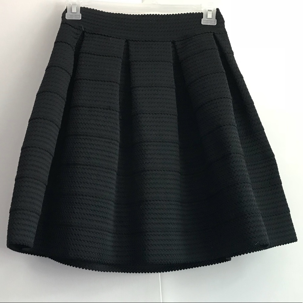 Above the knee black skirt.